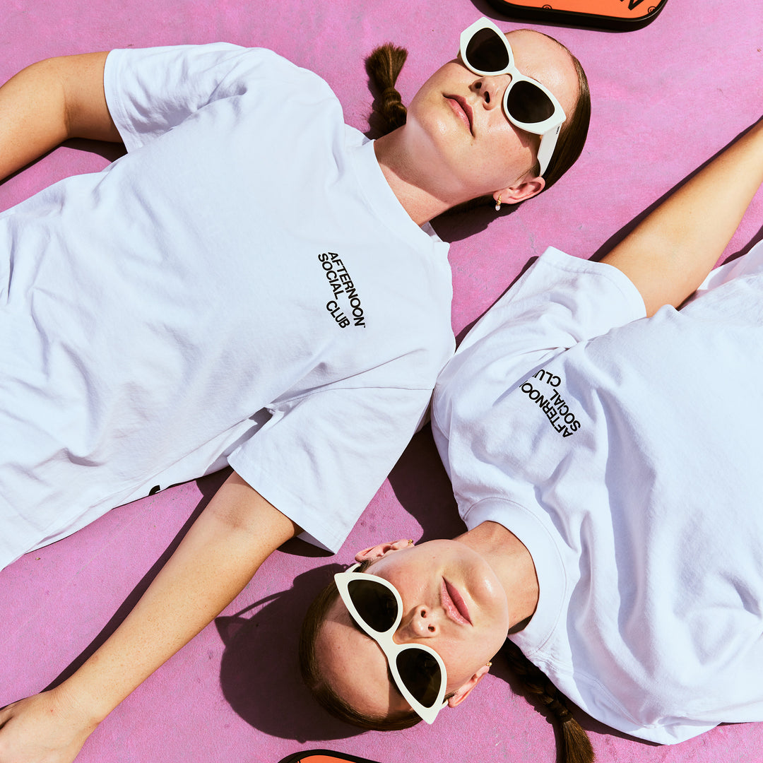 Female Models wearing a white Afternoon Social Club Heavy Tee 