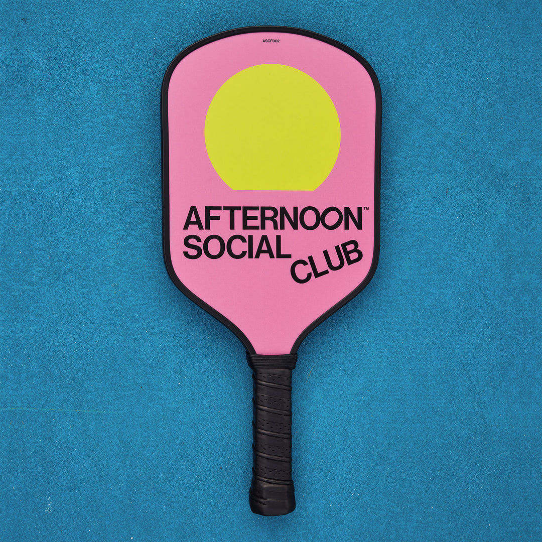 Pink Fiberglass Pickleball Paddle featuring Afternoon Social Club logo and yellow sun