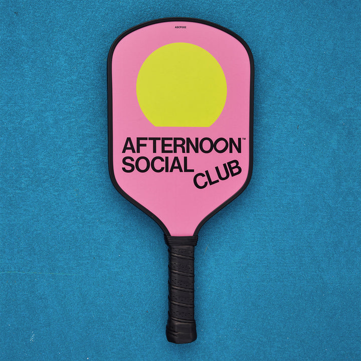Pink Fiberglass Pickleball Paddle featuring Afternoon Social Club logo and yellow sun
